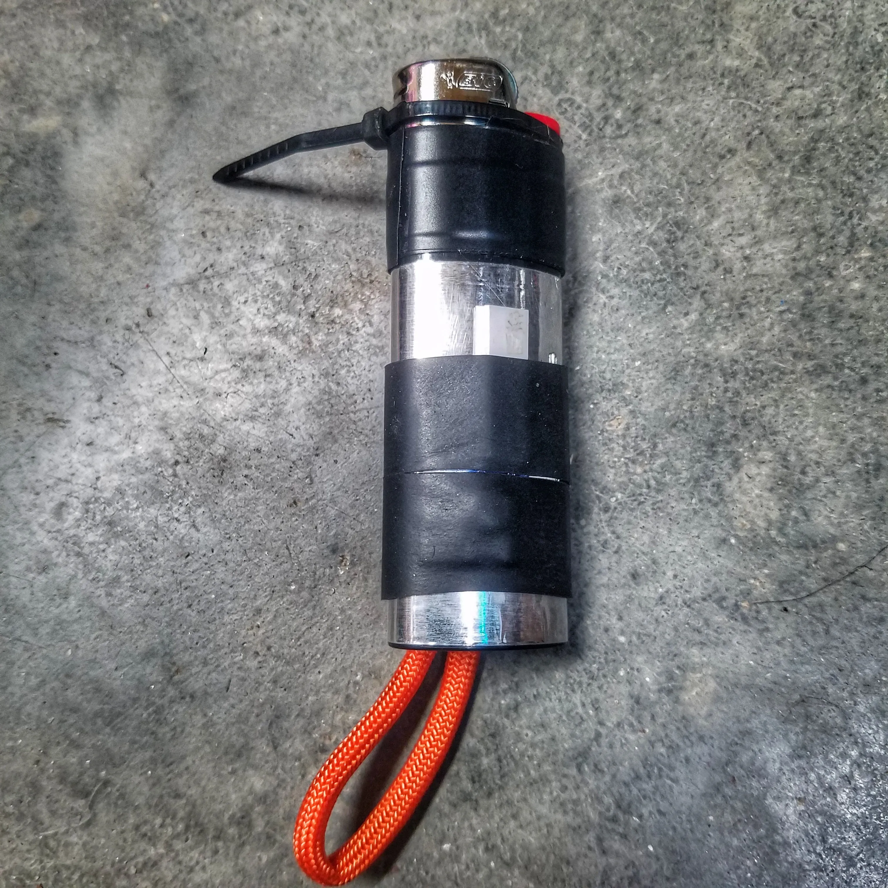 Survival Kit Lighter - Fire Starter outfitted with supplies.